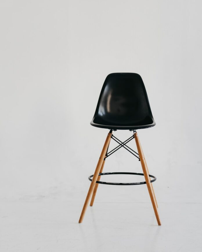 Photo by Eugene Chystiakov black chair on white snow