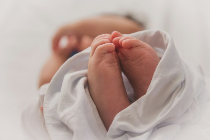 Photo by Luma Pimentel baby covered with white blanket