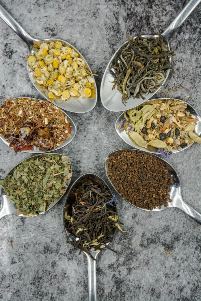 Photo by Alice Pasqual seven different spices and herbs on gray stainless steel spoons