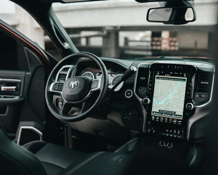 Photo by Brock Wegner black car gps turned on in car