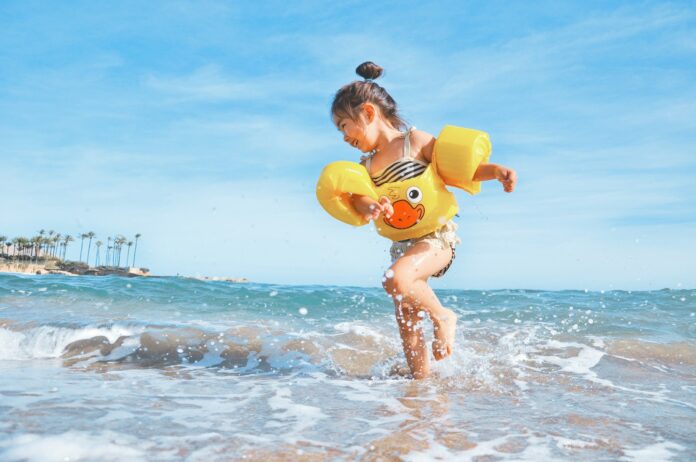 Photo by Leo Rivas girl playing beside body of water during daytime