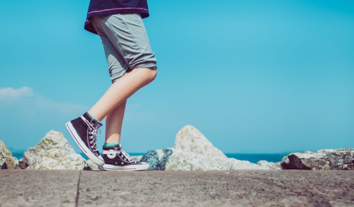 Photo by Eric Masur person walking on gray concrete pavement