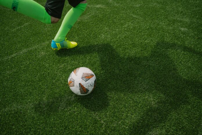 Photo by Max Zindel a football ball on the grass