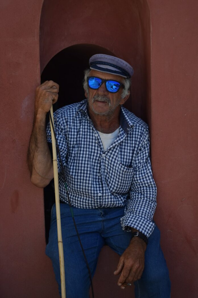 Photo by micaela Marianthi man with sunglasses sitting