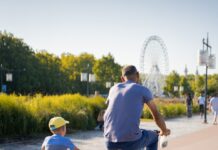 가족 건강을 위한 운동 프로그램 man in blue t-shirt riding on black bicycle during daytime