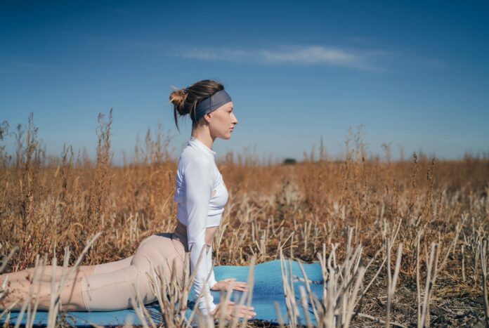 Photo by Oksana Taran woman in white long sleeve shirt and white pants sitting on blue wooden chair during daytime