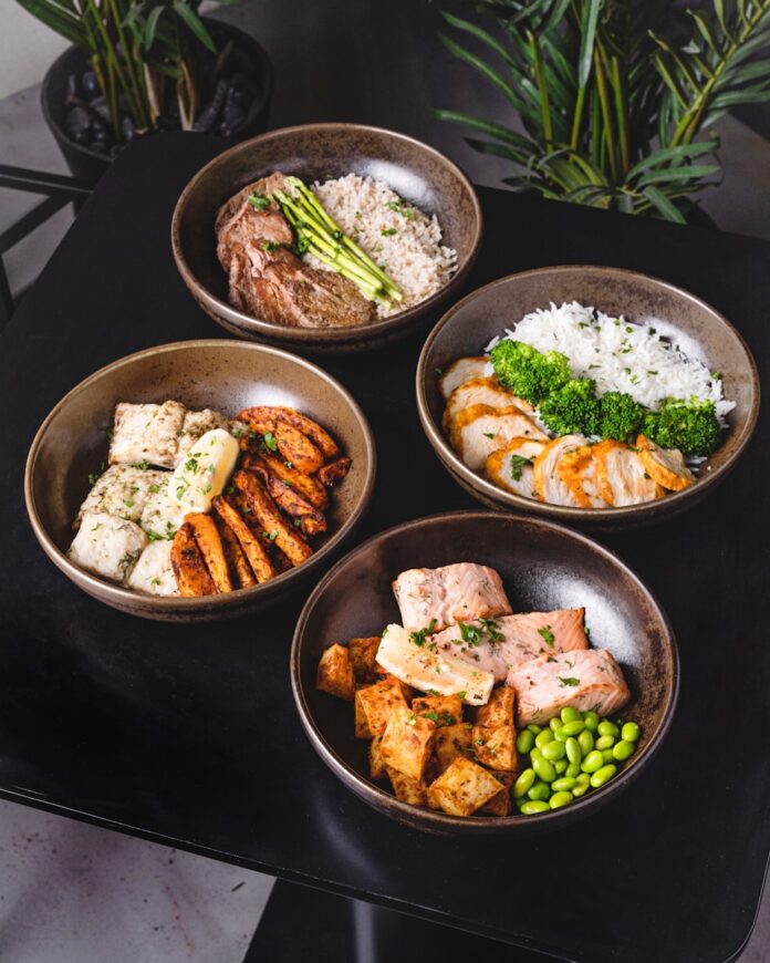 Photo by Eiliv Aceron cooked food on black ceramic bowls