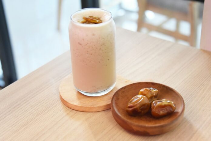 Photo by novila misastra a glass of milk and some food on a table