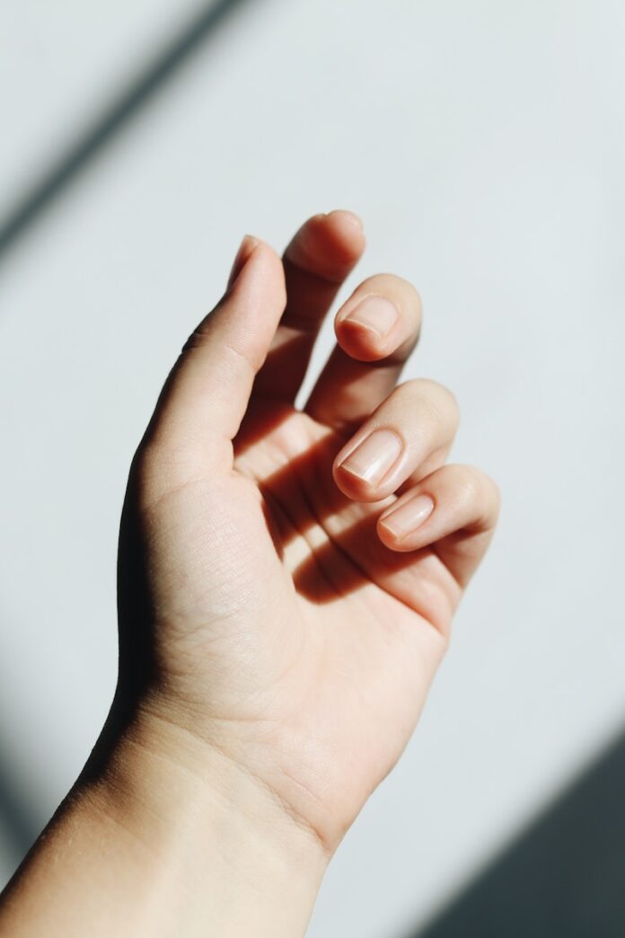 Photo by Jessica Mangano persons left hand on white table