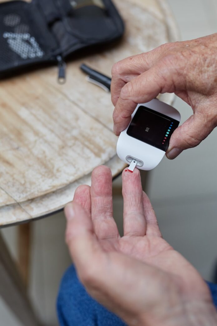 Photo by Sweet Life a person blood sugar testing using a gluco-meter