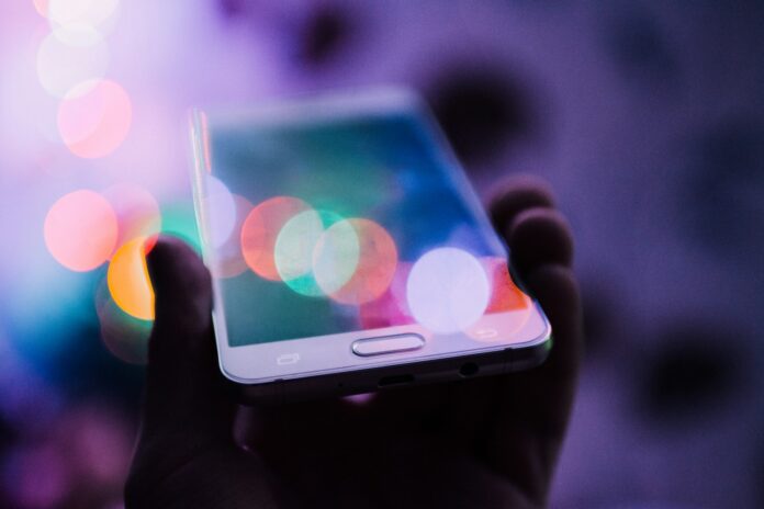 Photo by Rodion Kutsaiev person holding smartphone