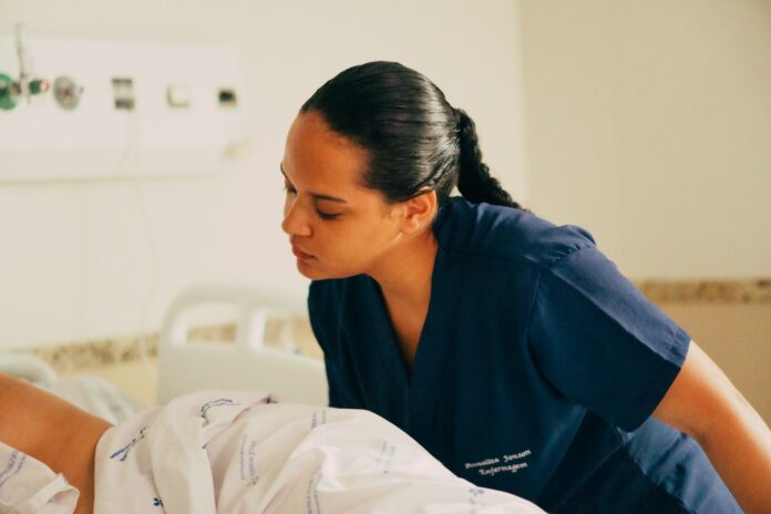 Photo by Maria Luísa Queiroz A nurse is attending to a patient in a hospital.