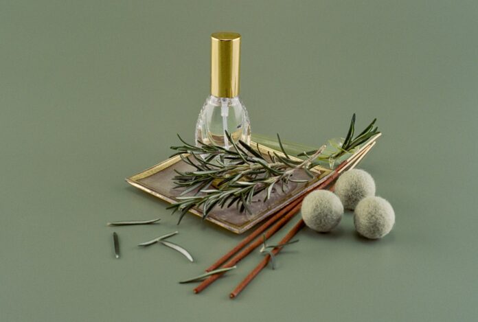 Photo by Mariya a bottle of perfume sitting on top of a table