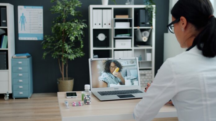 Photo by Vitaly Gariev Doctor consulting patient via video call on laptop.