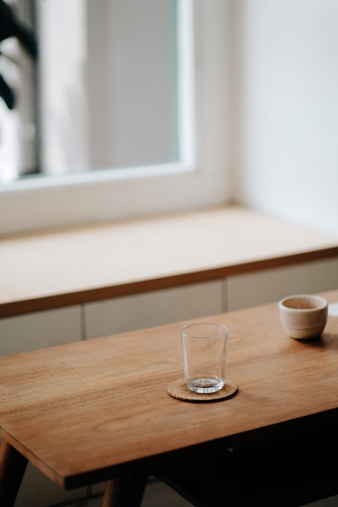 Photo by bady abbas clear drinking glass on brown wooden table